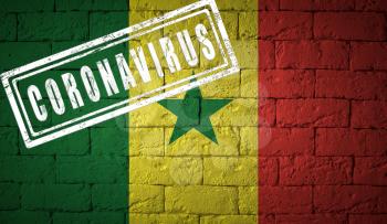 Flag of the Senegal on brick wall texture. stamped of Coronavirus. Corona virus concept. On the verge of a COVID-19 or 2019-nCoV Pandemic. Novel Chinese Coronavirus outbreak