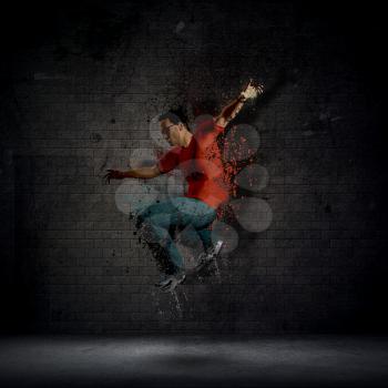 Abstract grunge man dancing against a dark brick wall