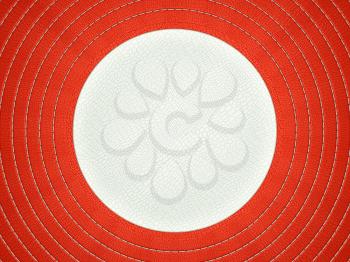 Red and white stitched circle shape on alligator skin. Large resolution