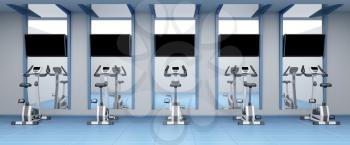 Exercise bikes in a row at fitness center