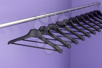 Plastic hangers hanging on rod in the closet