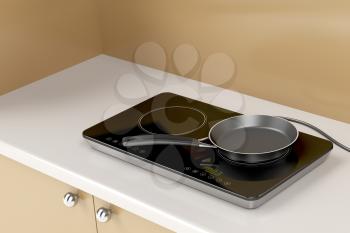 Double induction cooktop with frying pan in the kitchen