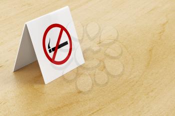 No smoking sign on wooden table in the restaurant or cafe