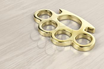 Golden brass knuckles on wooden background 