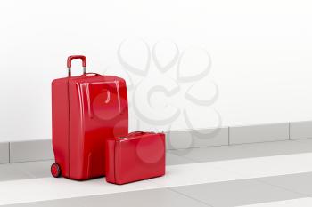 Red suitcase and briefcase at the airport