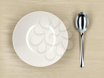 Top view of white empty soup bowl and silver spoon on wood table