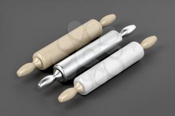 Three rolling pins from different materials on grey background