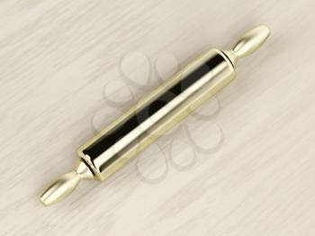 Golden rolling pin on the wooden table, top view