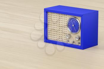 Blue retro radio on wood background