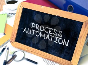 Process Automation Handwritten by White Chalk on a Blackboard. Composition with Small Chalkboard on Background of Working Table with Office Folders, Stationery, Reports. Blurred, Toned 3d Image. 