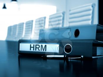 HRM - Illustration. Hrm. Illustration on Blurred Background. HRM - File Folder on Working Desktop. HRM - Business Concept on Blurred Background. 3D Render.