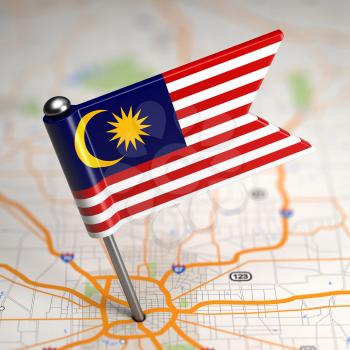 Small Flag of Malaysia Sticked in the Map Background with Selective Focus.