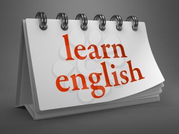 Learn English - Red Words on White Desktop Calendar Isolated on Gray Background.