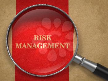 Risk Management Concept. Magnifying Glass on Old Paper with Red Vertical Line Background.