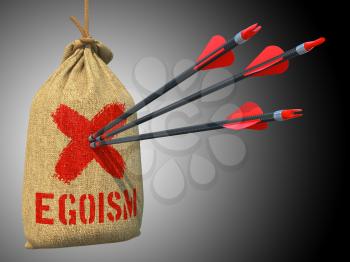 Egoism - Three Arrows Hit in Red Target on a Hanging Sack on Grey Background.