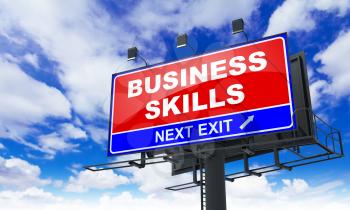 Business Skills Inscription on Red Billboard on Sky Background.