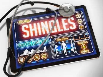 Medical Tablet with the Diagnosis of Shingles on the Display and a Black Stethoscope on White Background.