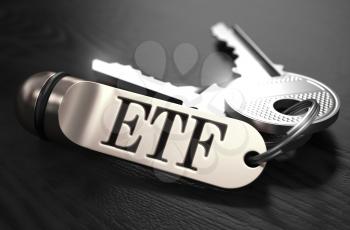 ETF - Exchange Traded Fund - Concept. Keys with Keyring on Black Wooden Table. Closeup View, Selective Focus, 3D Render. Black and White Image.