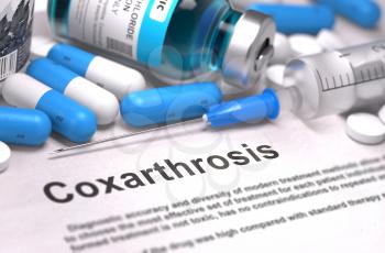 Coxarthrosis - Printed Diagnosis with Blue Pills, Injections and Syringe. Medical Concept with Selective Focus.