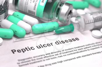 Peptic Ulcer Disease - Printed Diagnosis with Blurred Text. On Background of Medicaments Composition - Mint Green Pills, Injections and Syringe.