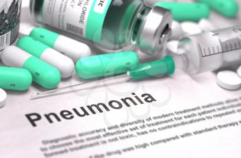 Pneumonia - Printed Diagnosis with Blurred Text. On Background of Medicaments Composition - Mint Green Pills, Injections and Syringe.