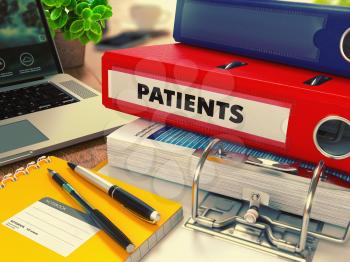 Red Office Folder with Inscription Patients on Office Desktop with Office Supplies and Modern Laptop. Business Concept on Blurred Background. Toned Image.