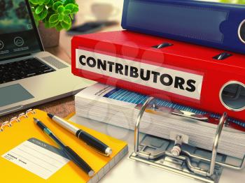 Red Office Folder with Inscription Contributors on Office Desktop with Office Supplies and Modern Laptop. Business Concept on Blurred Background. Toned Image.