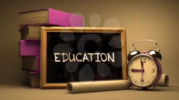 Handwritten Education on a Chalkboard. Composition with Chalkboard and Stack of Books, Alarm Clock and Rolls of Paper on Blurred Background. Toned Image.