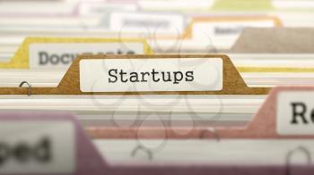 Startups Concept on Folder Register in Multicolor Card Index. Closeup View. Selective Focus.