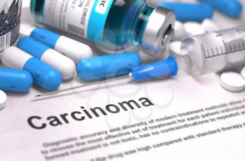 Carcinoma - Printed Diagnosis with Blurred Text. On Background of Medicaments Composition - Blue Pills, Injections and Syringe.