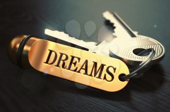 Keys to Dreams - Concept on Golden Keychain over Black Wooden Background. Closeup View, Selective Focus, 3D Render. Toned Image.