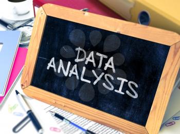 Data Analysis Handwritten on Chalkboard. Composition with Small Chalkboard on Background of Working Table with Ring Binders, Office Supplies, Reports. Blurred Background. Toned Image.