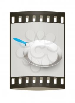 Pan with handle on light gray background. The film strip