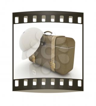 Brown traveler's suitcase and peaked cap on a white background. The film strip