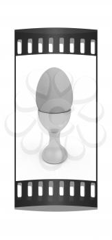 Easter egg on gold egg cups on a white background. The film strip with place for your text