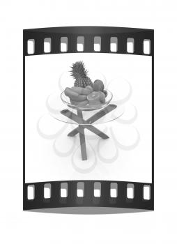 Citrus in a glass dish on exotic glass table with wooden legs on a white background. The film strip