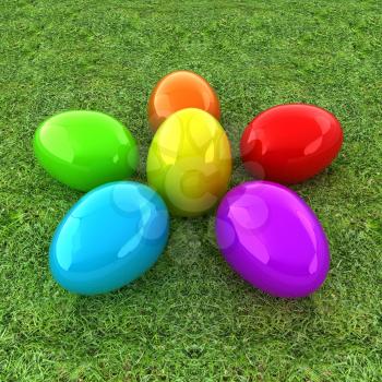 Colored Easter eggs as a flower on a green grass