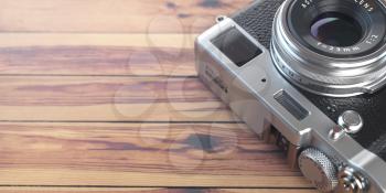 Retro vintage camera on wood table background. Space for text. 3d illustration