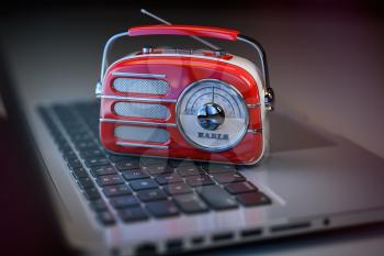 Online radio live. Vintage radio on laptop keyboard. 3d illustration