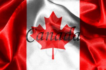 Canadian National Flag With Maple Leaf On It in Red And White Colors With Canada Written On It