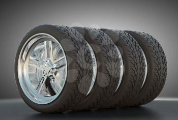 Group of four automotive wheels with studio light background