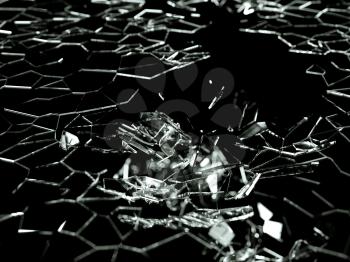 Destructed and splitted glass pieces on black with shallow DOF