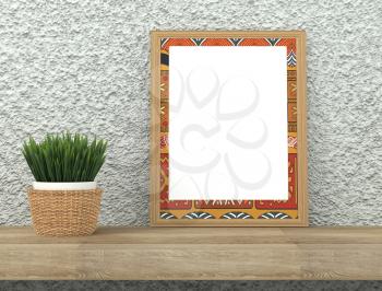 Mock up interior. Frame with bright ethnic ornament. Green grass in a pot on a wooden table. Rough gray plastered wall. 3d rendering
