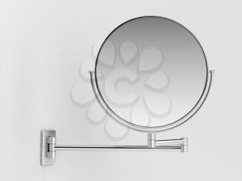 Silver makeup mirror on white wall 