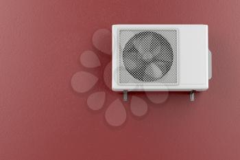 Air conditioner mounted on the red wall 