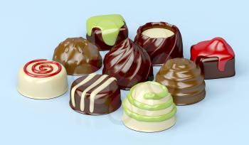 Selection of different chocolate candies on blue background 
