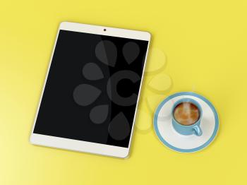 Tablet computer and coffee cup on yellow table