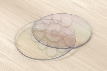 Pair of eyeglasses lens on wood background 