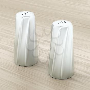 Metal salt and pepper shakers on wood background  