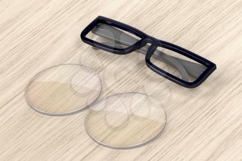 Plastic eyeglasses frame and uncut lens on wood background